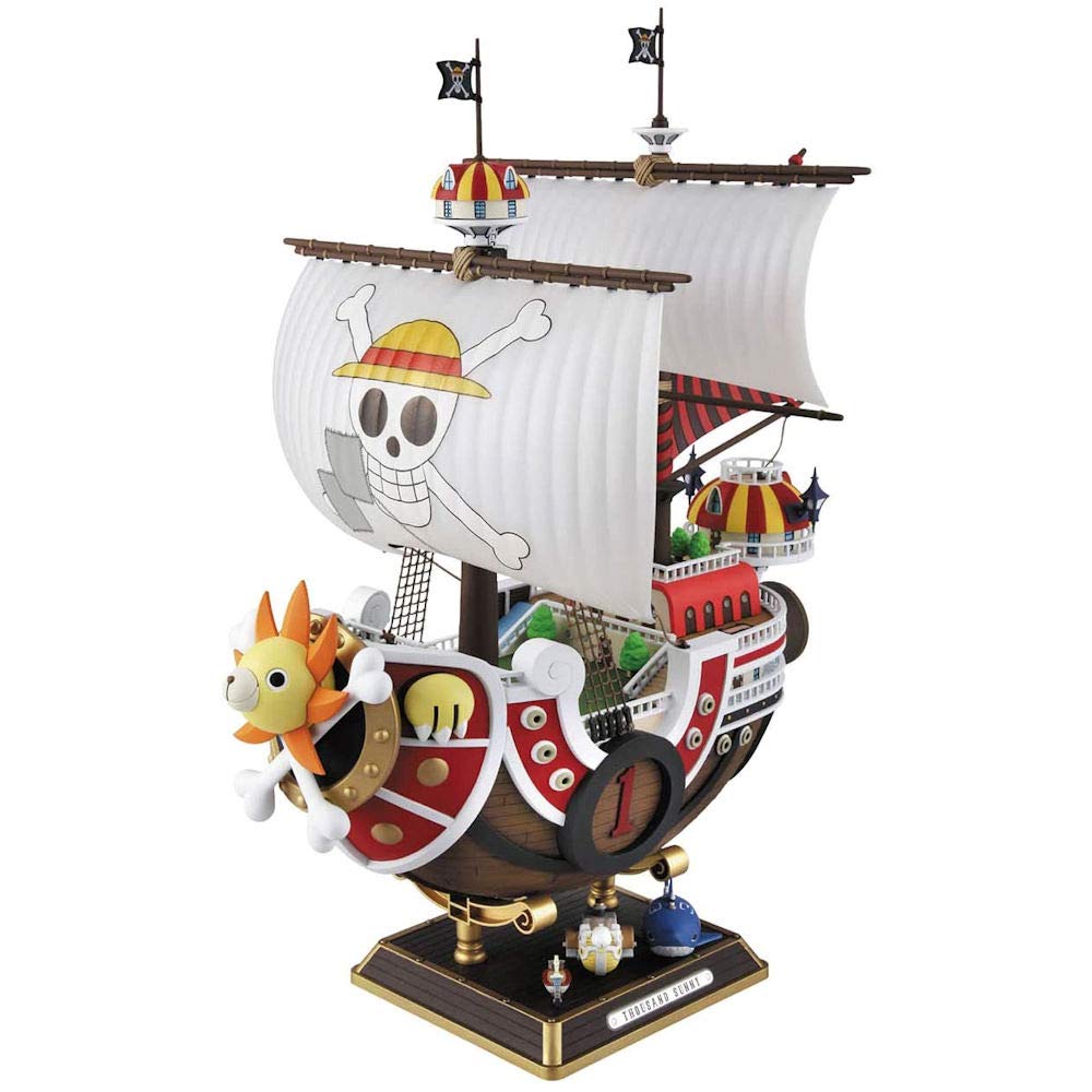 Model kit of the Thousand Sunny ship from One Piece, featuring detailed sails, vibrant colors, and iconic pirate motifs.