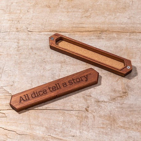 Elegant Sapelli wood dice box featuring an engraved message, "All dice tell a story," with a smooth, natural finish.