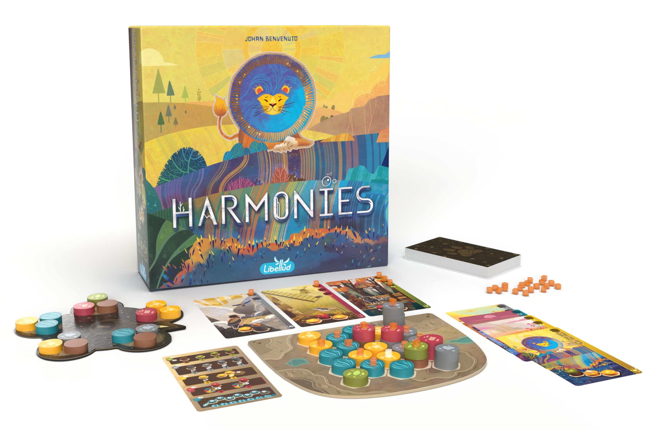 Colorful board game "Harmonies" displayed with components including tokens, cards, and a vibrant box cover featuring a lion.