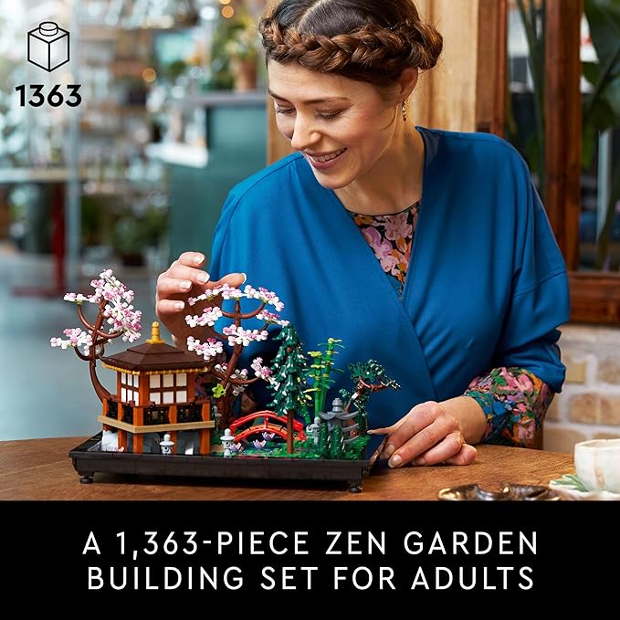 Adult woman assembling the LEGO Icons Tranquil Garden set, featuring cherry blossoms and a serene landscape.