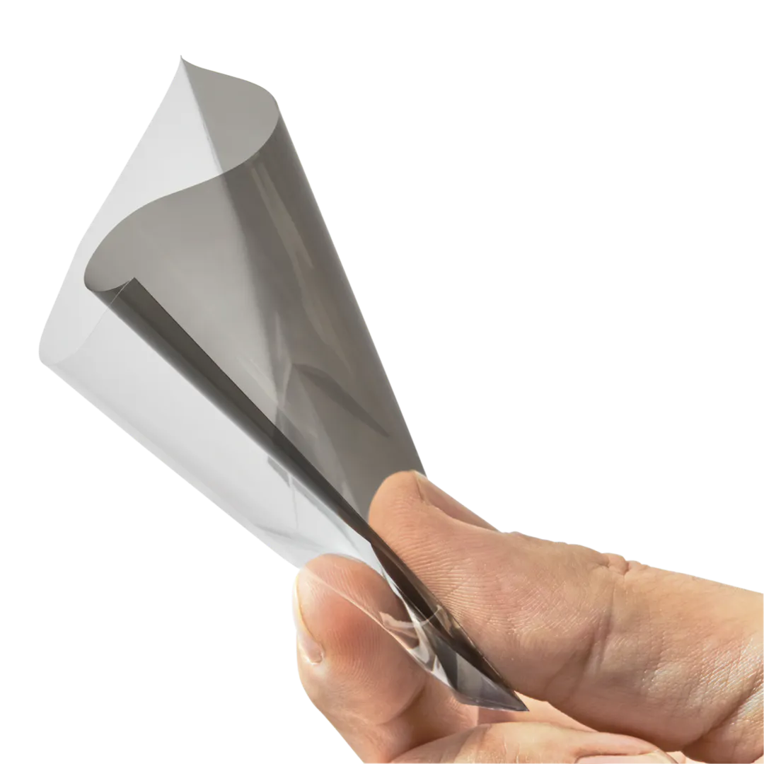 Hand holding a transparent smoke-colored inner card sleeve, designed for protecting trading cards.