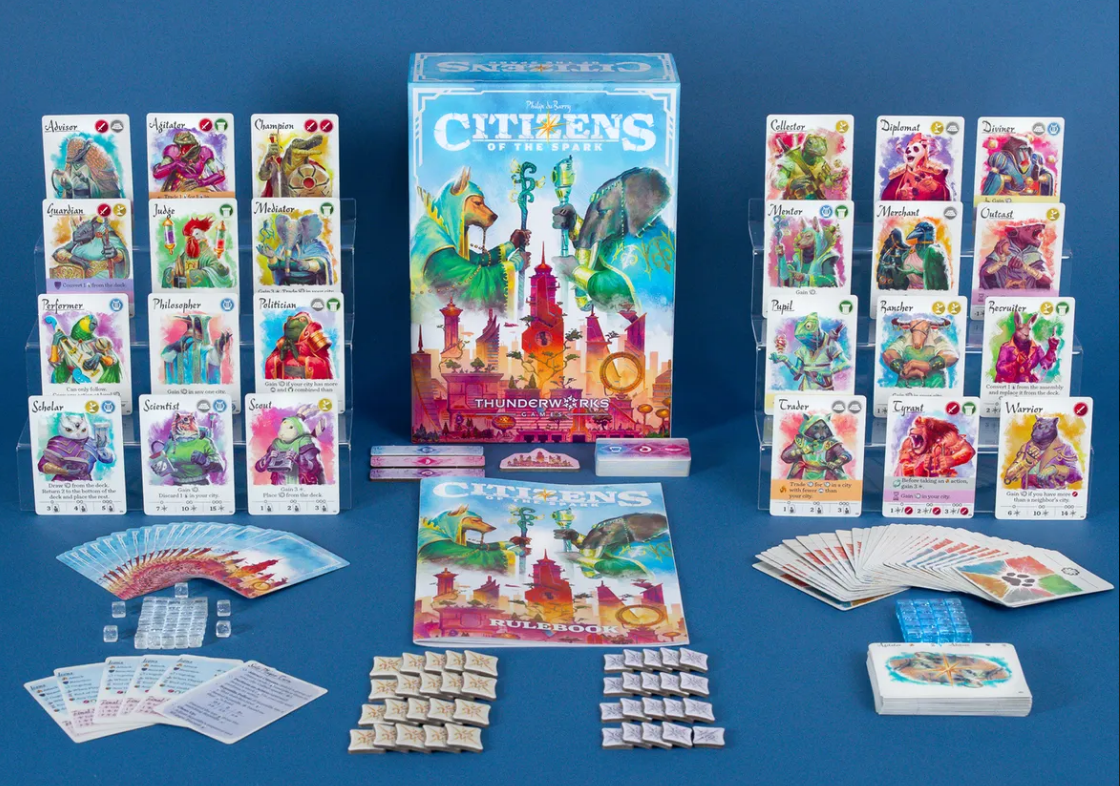 Citizens of the Spark board game set with colorful character cards, tokens, and rulebooks displayed on a blue background.