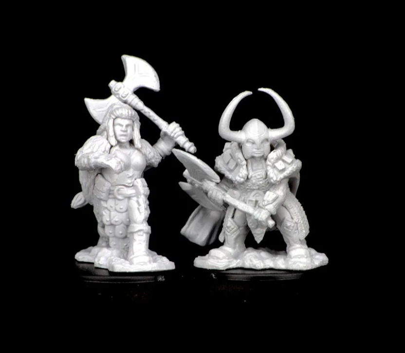 Unpainted miniatures of a female dwarf barbarian wielding an axe and a male warrior with horns, both for Dungeons & Dragons.
