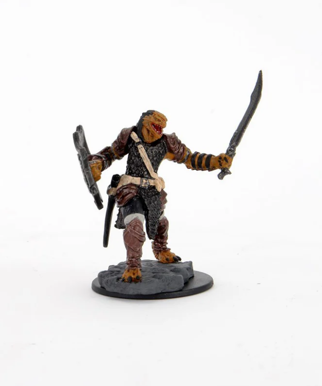 Dragonborn female paladin miniature from Dungeons & Dragons, wielding swords and standing on a rocky base.