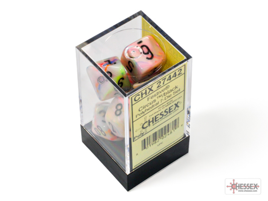 Chessex Festive Circus/Black 7-die set displayed in a clear box, featuring colorful dice with black numbers.