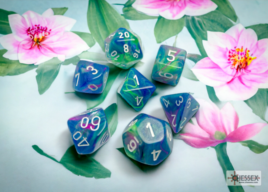 Chessex Festive Waterlily White 7 die set featuring colorful, marbled dice with white numbers on a floral background.