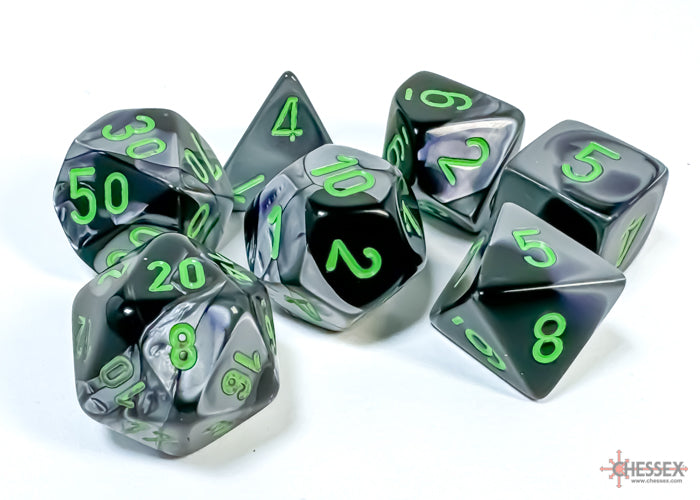 Chessex Gemini Black-Grey/Green 7-die set featuring translucent dice with green numbers and a swirling black-grey design.