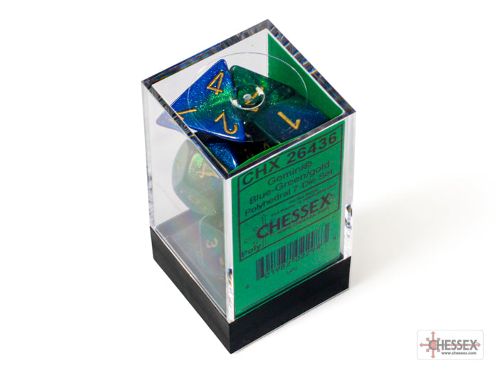 Chessex Gemini Blue-Green/Gold 7-die set displayed in a clear box, featuring vibrant blue-green colors with gold numbering.