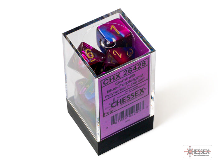 Chessex Gemini Blue-Purple/Gold 7-die set displayed in a clear box with a purple label, featuring vibrant, multi-colored dice.