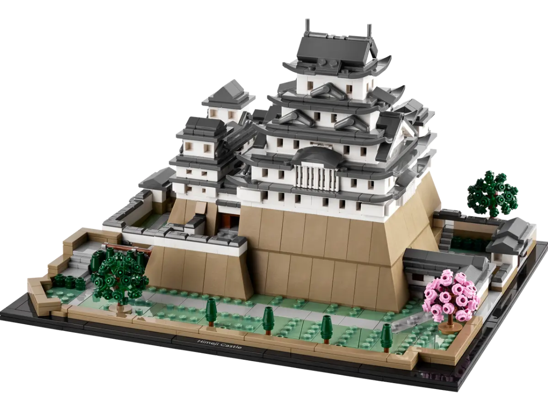 Detailed LEGO model of Himeji Castle featuring intricate architecture, surrounding gardens, and cherry blossom trees.