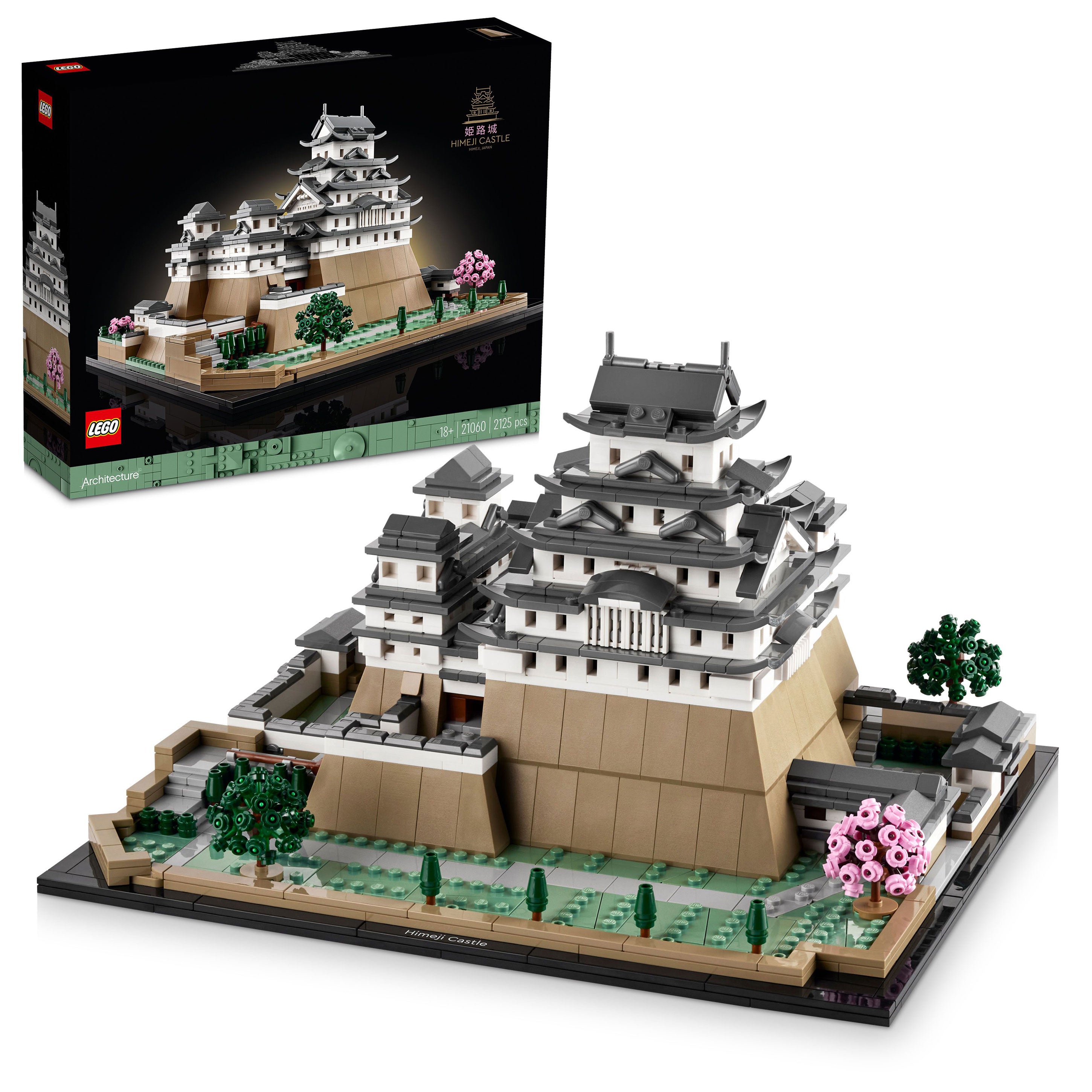 LEGO Himeji Castle set featuring intricate architectural details, surrounded by trees and pink blossoms, with the box displayed.