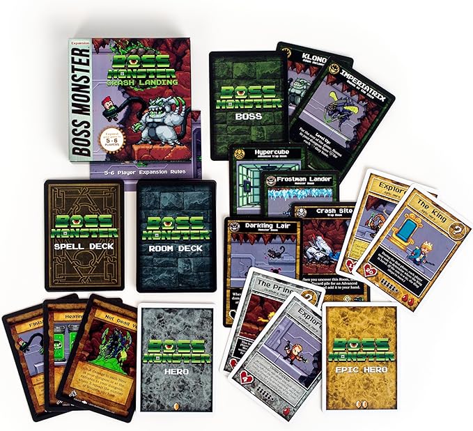 Boss Monster: Crash Landing Expansion box with cards spread out, including hero, spell, and room decks for gameplay.