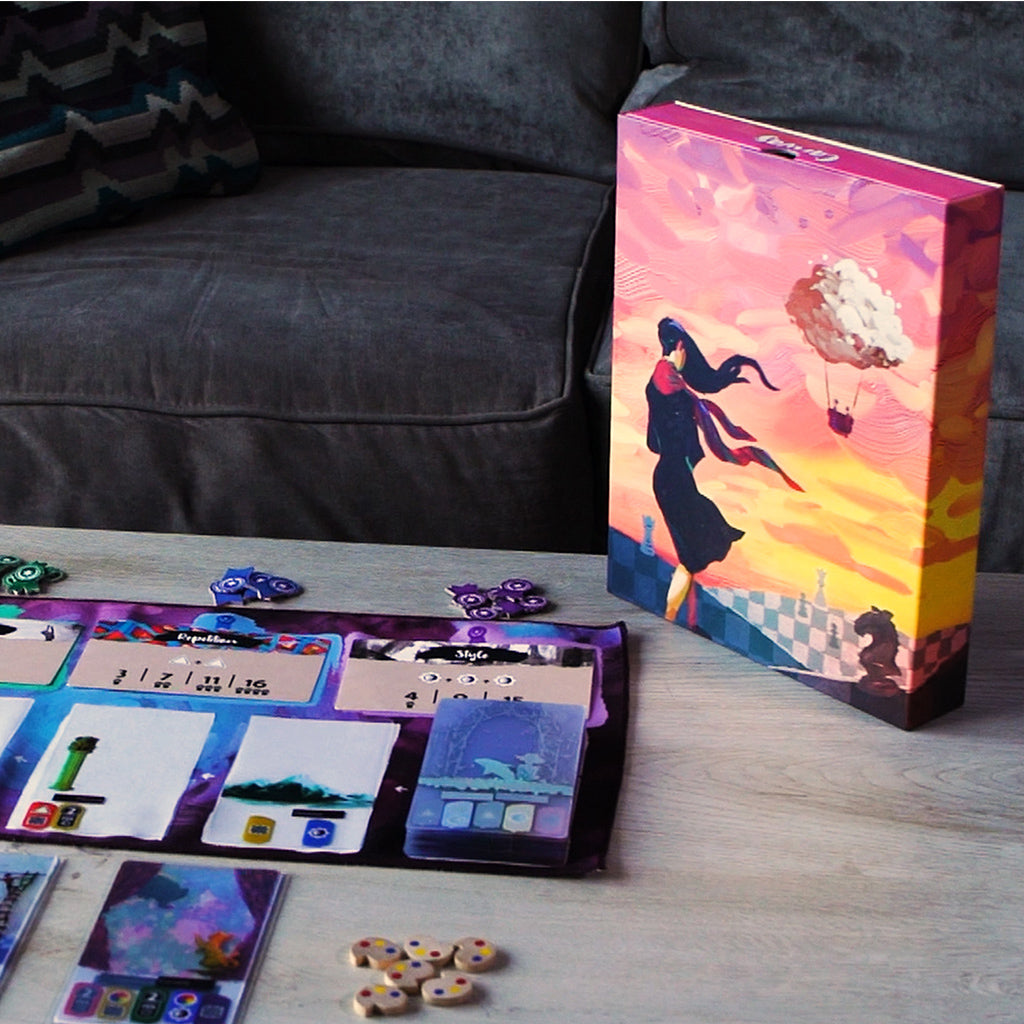Colorful board game Canvas displayed on a table with game components, including cards and tokens, on a cozy couch backdrop.