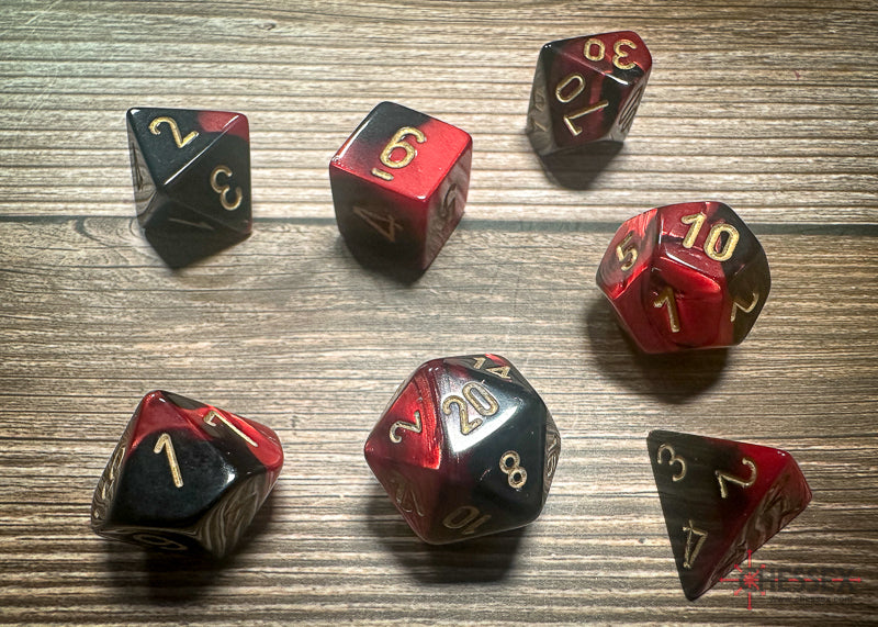Chessex Gemini Black-Red/Gold Polyhedral 7-Dice Set featuring vibrant black and red colors with gold numbering.