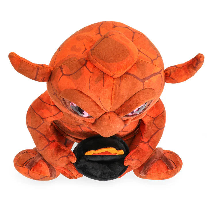 Dungeons & Dragons 50th Anniversary plush statue featuring a red creature with large eyes, holding a black object.