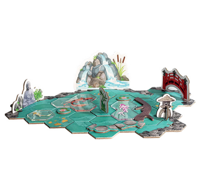 Colorful Koi board game setup featuring hexagonal tiles, a pond, decorative elements, and game pieces.