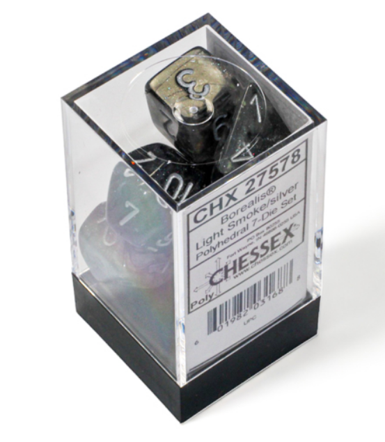Chessex Borealis Light Smoke and Silver Luminary 7-die set displayed in a clear box, showcasing its polyhedral design.