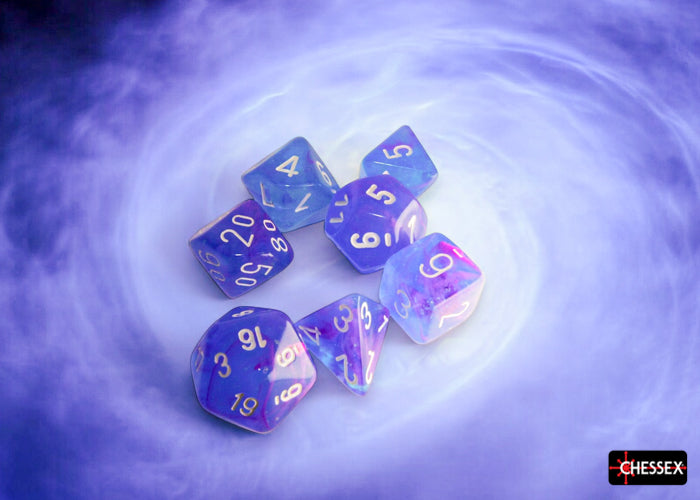 Chessex Nebula Aura/White Luminary polyhedral 7-dice set featuring vibrant colors and gold numbering on a cosmic background.