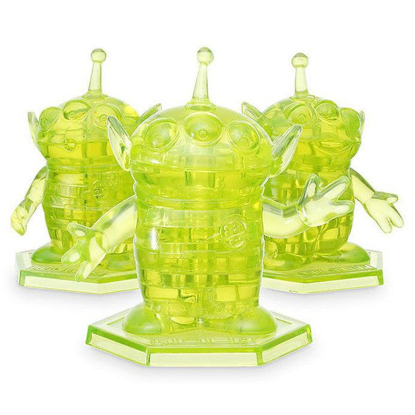 3D crystal puzzle of Toy Story aliens, featuring three translucent green figures with arms outstretched on hexagonal bases.