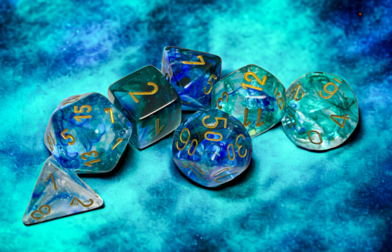 Chessex Nebula Oceanic Gold Luminary 7 Die Set featuring vibrant blue and gold dice on a textured blue background.