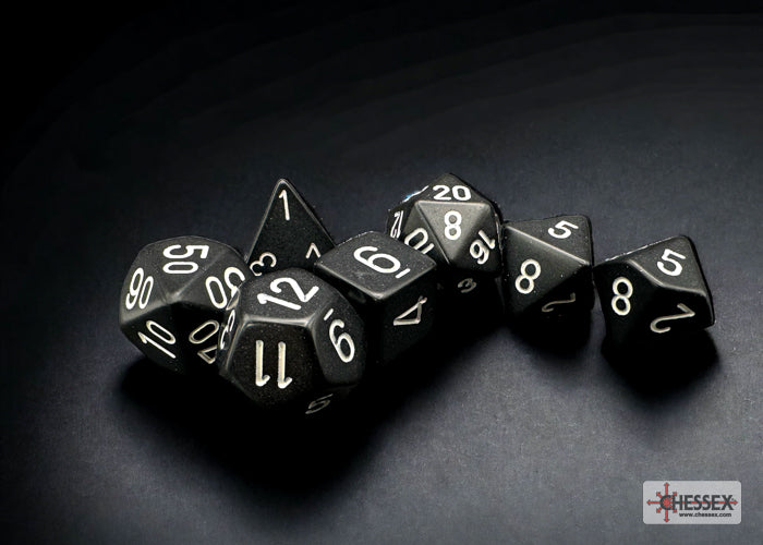 Chessex opaque black 7-die set featuring white numbers, ideal for tabletop gaming and role-playing games.
