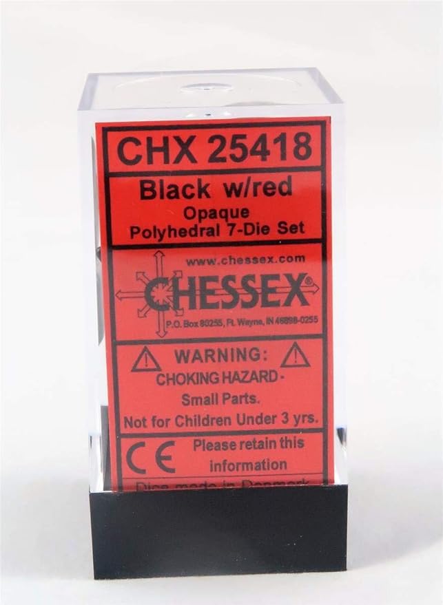 Chessex opaque black and red 7-die set in a clear display box with warning label for small parts.