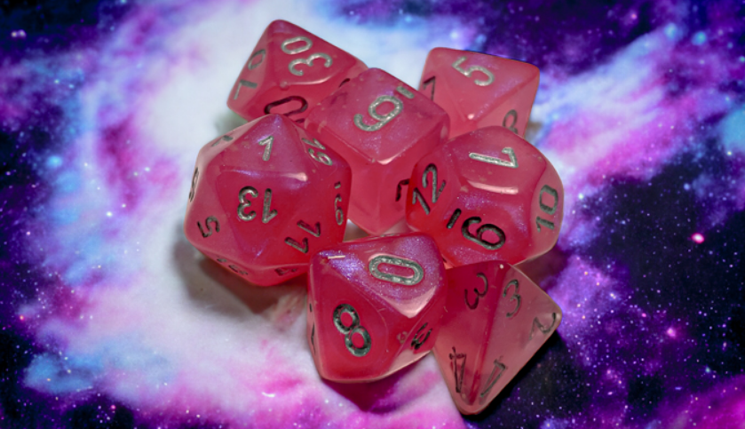 Chessex Borealis pink and silver luminary polyhedral 7-die set on a cosmic background, showcasing vibrant colors and clear numbers.