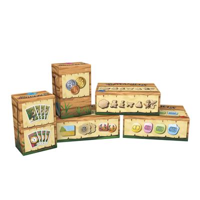 Five colorful boxes of the board game Botanicus, featuring cards, tokens, and game pieces, arranged aesthetically.