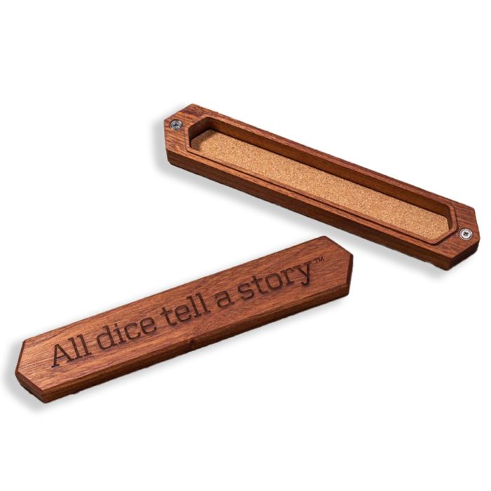 Sapelli wood dice box with a cork interior and engraved text "All dice tell a story," designed for tabletop gaming.