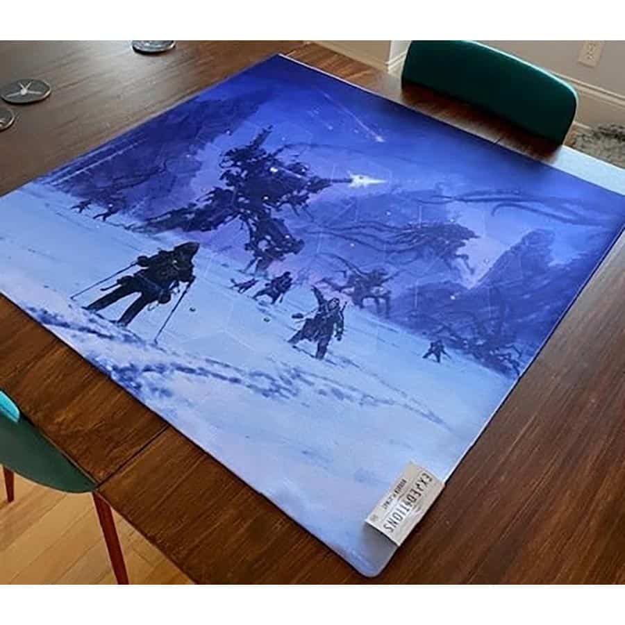 Expeditions playmat featuring a snowy landscape with explorers and a large mechanical structure in the background.