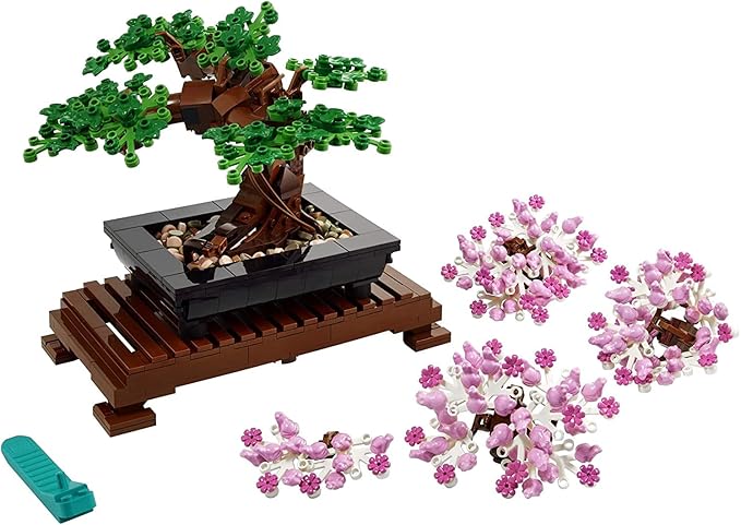 LEGO Botanicals Bonsai Tree set featuring a detailed tree with green leaves, a black pot, and pink flower pieces on a wooden stand.