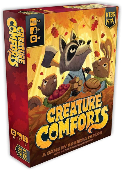 Colorful game box for Creature Comforts featuring a raccoon and two rabbits surrounded by autumn leaves and cozy items.