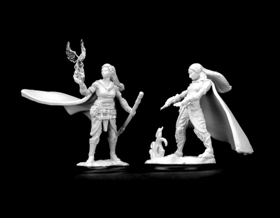 Unpainted miniatures of a female elf druid holding a staff and a magical flame, showcasing intricate details for tabletop gaming.