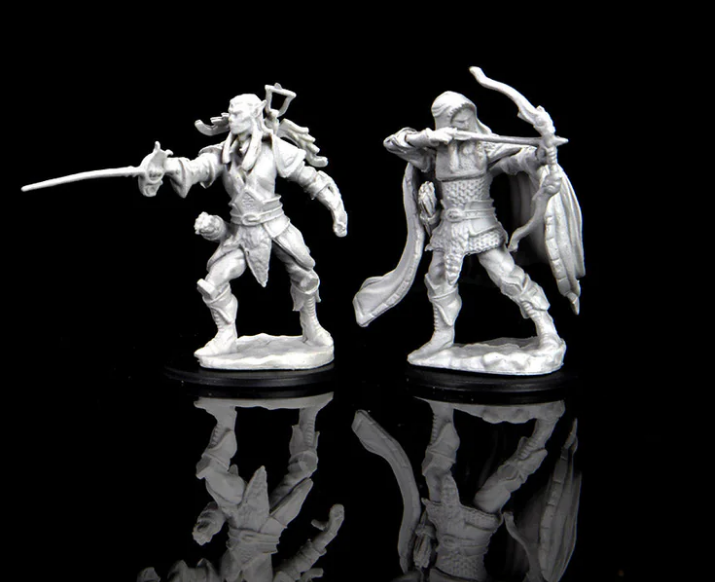 Unpainted miniatures of two male elf rogues for Dungeons & Dragons, featuring detailed poses and accessories.