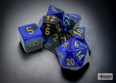 Chessex Gemini Black-Blue/Gold 7-die set featuring polyhedral dice with gold numbering on a blue and black swirl design.