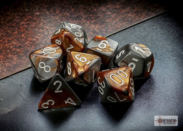 Chessex Gemini Copper/Steel 7-die set featuring marbled brown and gray dice with white numbers, arranged on a dark surface.