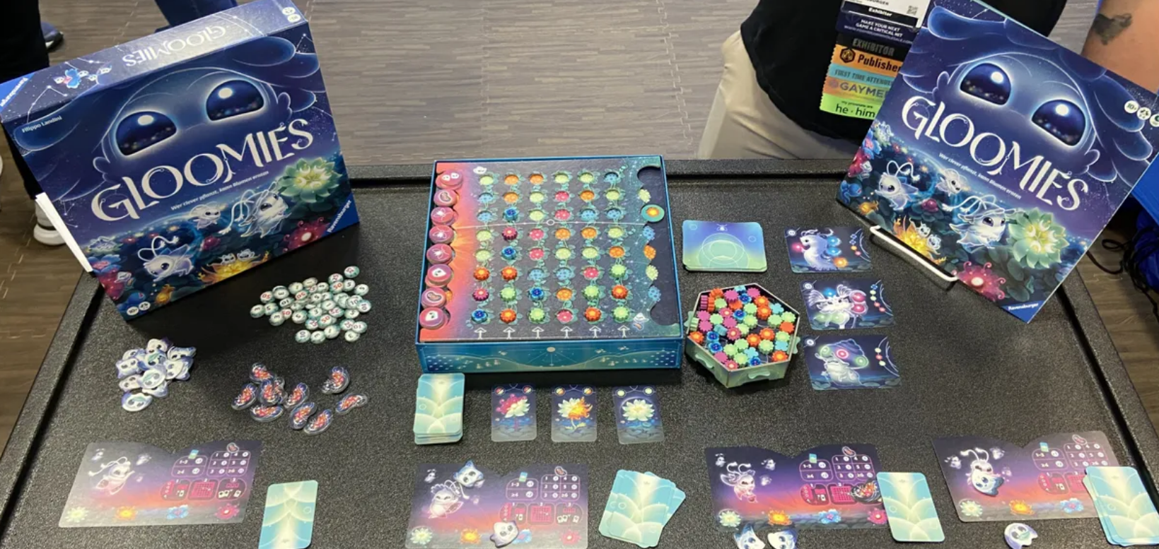 Colorful board game Gloomies displayed with game pieces, cards, and a vibrant game board, showcasing a whimsical theme.