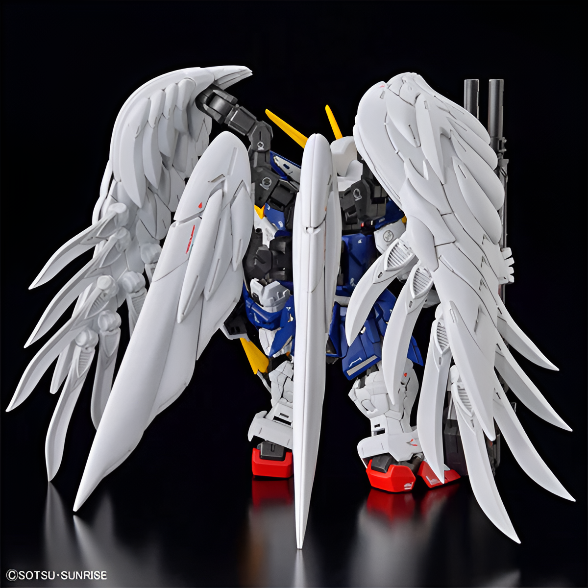 MGSD Gundam Wing model kit featuring detailed wings and vibrant colors, showcasing a dynamic pose against a dark background.