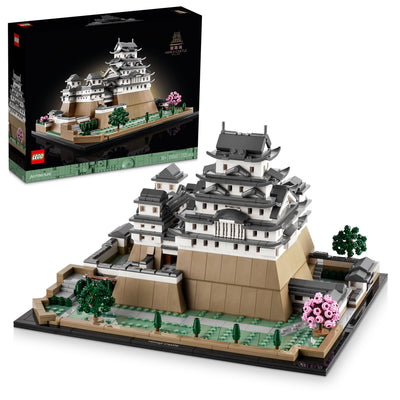 LEGO Himeji Castle set featuring intricate architectural details, surrounded by trees and pink blossoms, with the box displayed.