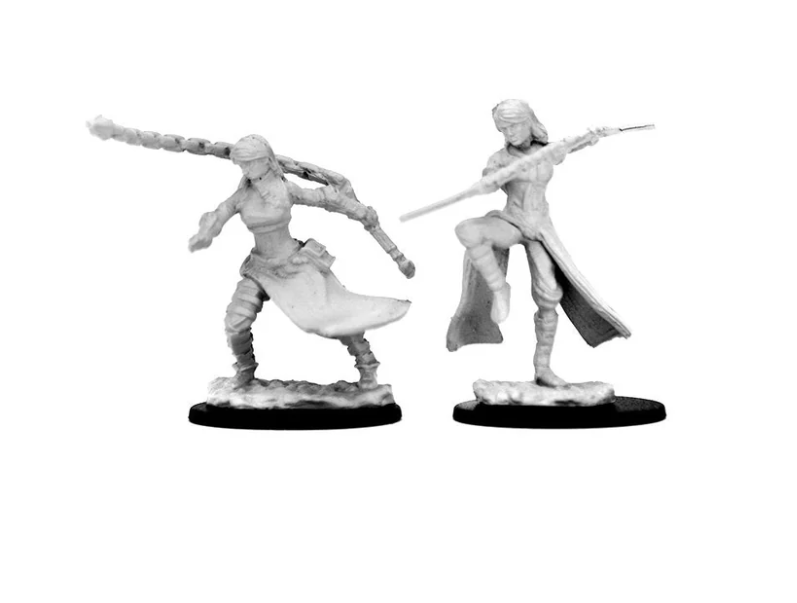 Unpainted miniatures of a human female monk from Dungeons & Dragons, featuring two dynamic poses with weapons.