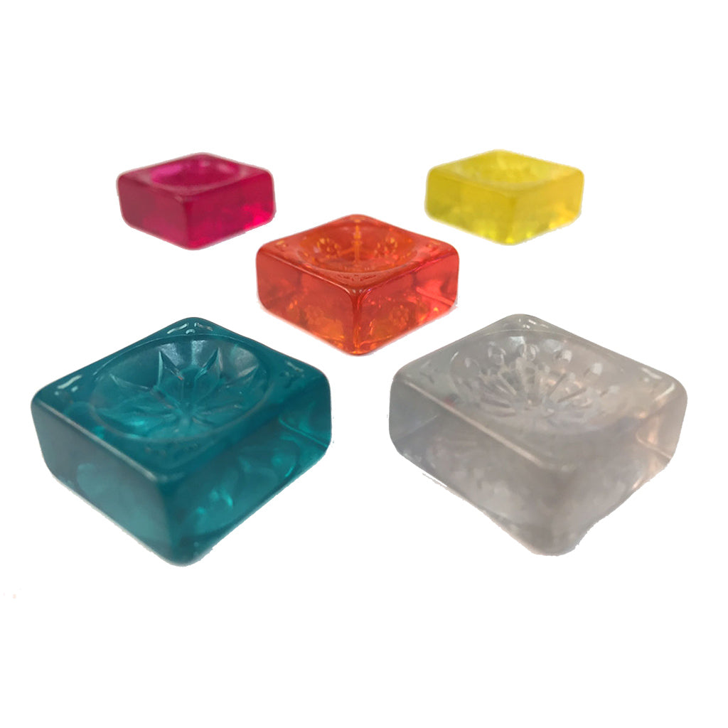 Colorful resin tiles from the board game Azul Stained Glass of Sintra, featuring various shapes and vibrant hues.