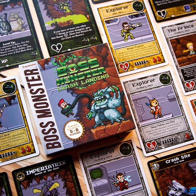 Boss Monster: Crash Landing expansion box surrounded by game cards featuring characters and gameplay elements.