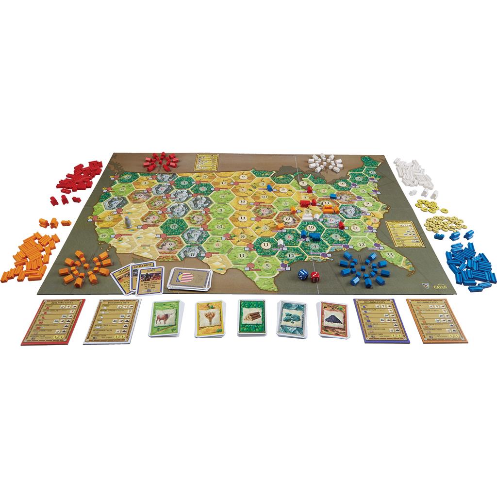 Catan - Settlers of America board game setup featuring a hexagonal map of the USA, resource cards, and player pieces in various colors.