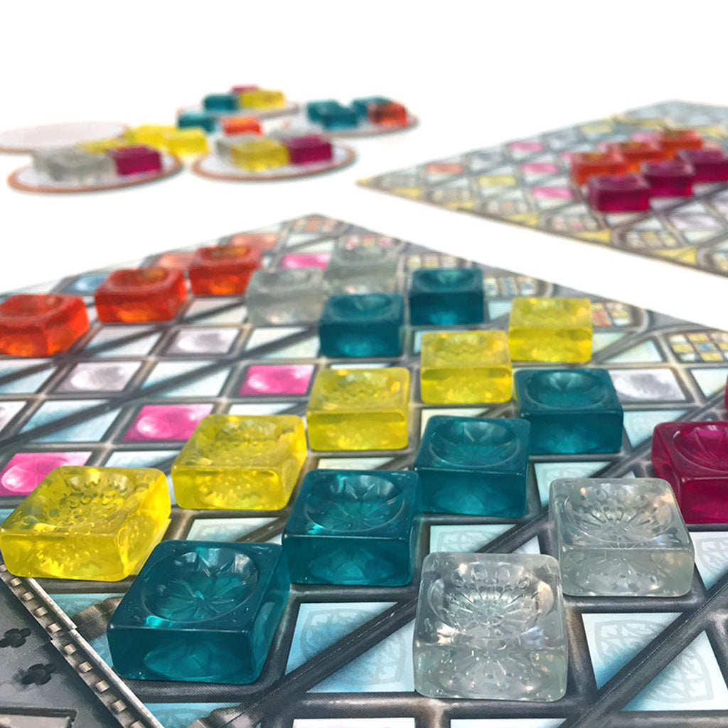 Colorful glass tiles arranged on a patterned board in Azul Stained Glass of Sintra, showcasing vibrant gameplay elements.