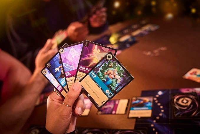 Disney Lorcana TCG Into the Inklands Booster Sleeve pack displayed with players holding colorful cards during gameplay.