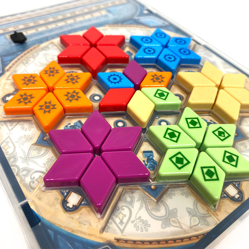 Colorful tiles from Azul Summer Pavilion Mini arranged in a star pattern on a decorative board.