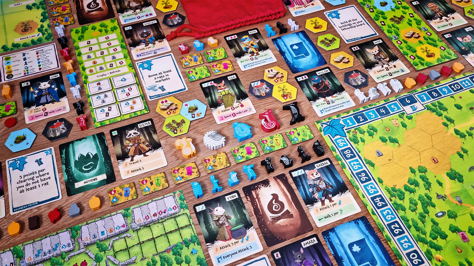 Colorful game board of Emberleaf featuring cards, tokens, and player pieces, showcasing a vibrant tabletop gaming setup.