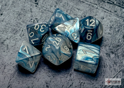 Chessex Lustrous Slate/White 7-die set featuring marbled blue and white dice with silver numbering on a textured background.