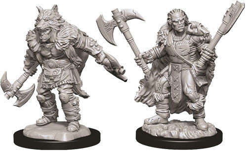 Unpainted miniatures of a male half-orc barbarian wielding axes, showcasing detailed armor and a fierce pose.