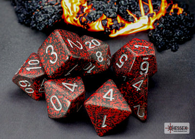 Chessex Speckled Silver Volcano Polyhedral 7-Dice Set featuring red and black dice with silver numbers against a fiery background.